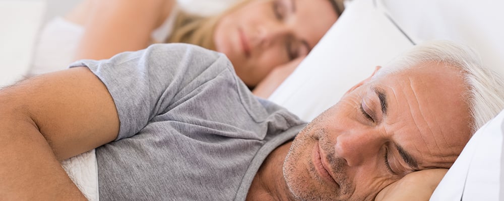Two people sleeping in bed blog header image