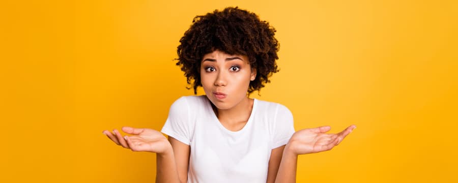 woman shrugging shoulders between the differences of incontinence briefs