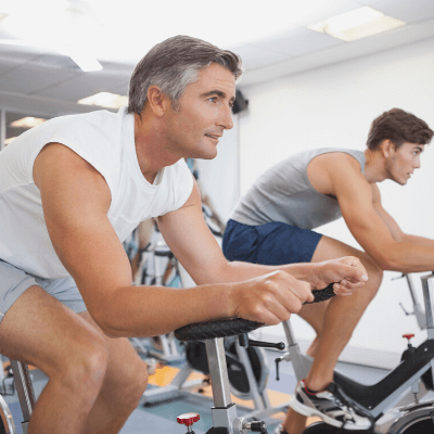 two men on bikes at the gym 