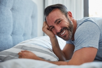 smiling man on bed
