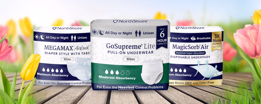 NorthShore incontinence products, including protective underwear and underpads, displayed among blooming tulips, symbolizing spring essentials for comfort and protection.