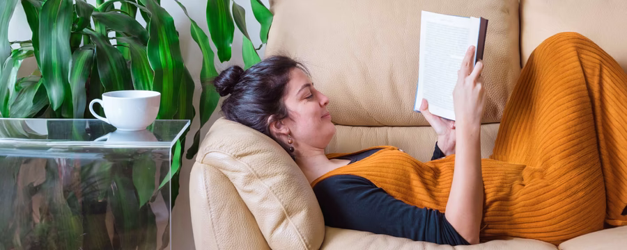 caregiver taking a self care moment with a book