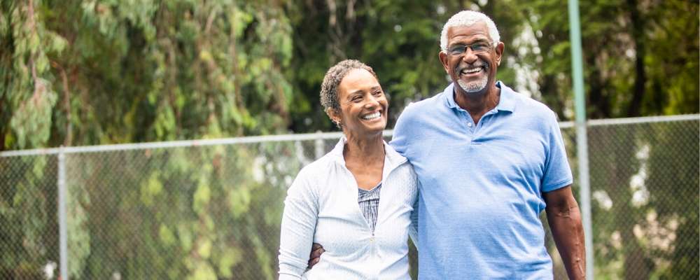 African American couple in tennis court