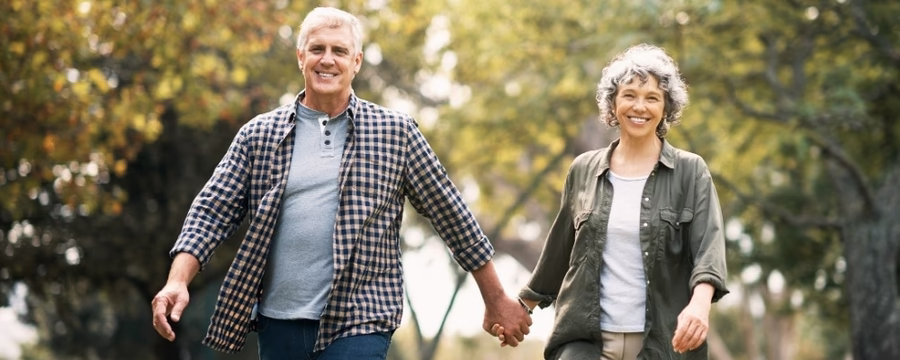 happy mature couple walking outdoors