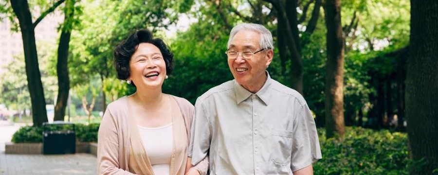 mature couple walking in park
