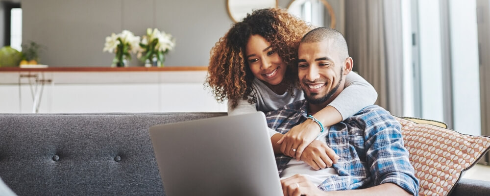 African American couple looking at laptop