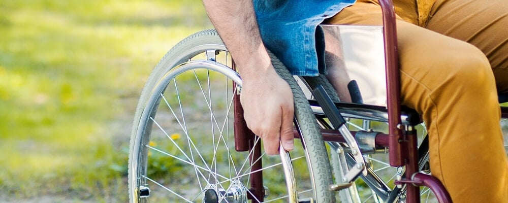 view of man's hand on wheelchair