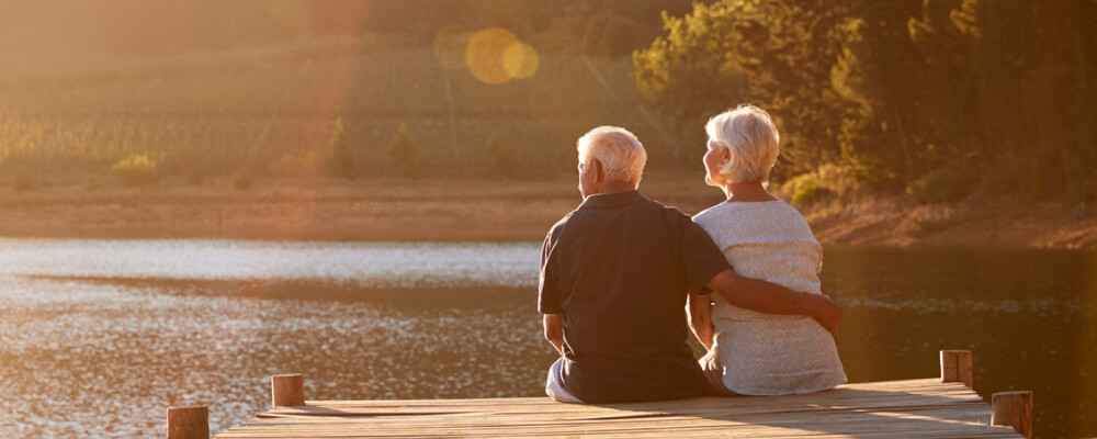 older couple sitting on dock