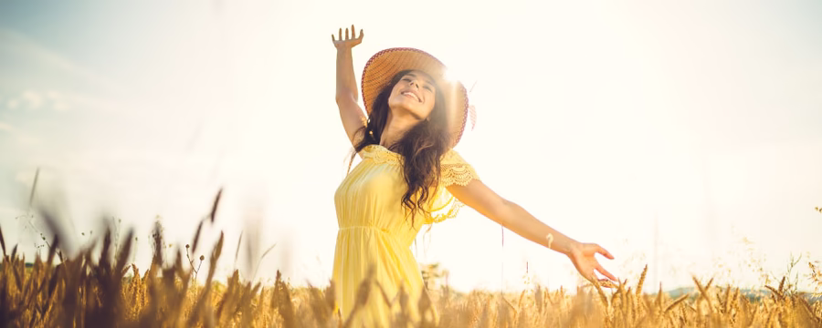 woman in field enjoying the sun