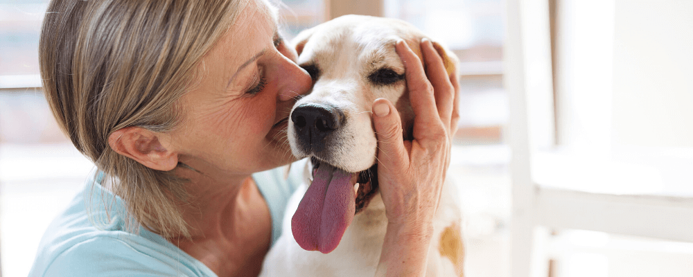 a woman hugging her beagle