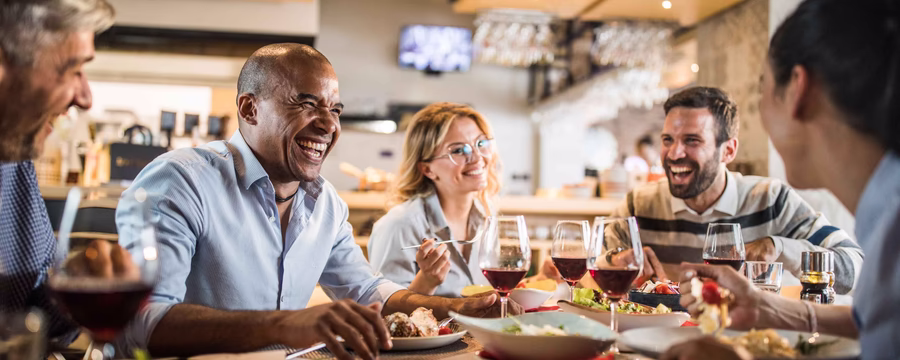 People gathered for at a table with food and drinks