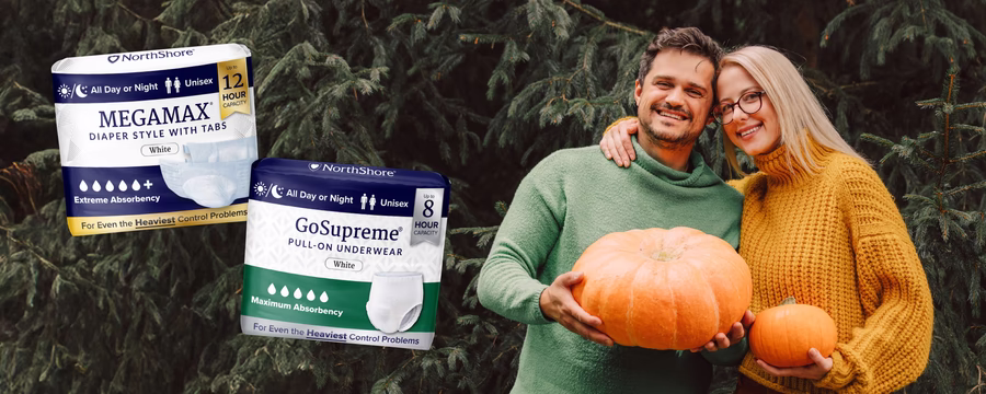Smiling couple holding pumpkins outdoors with NorthShore MEGAMAX diapers and GoSupreme underwear for fall incontinence protection