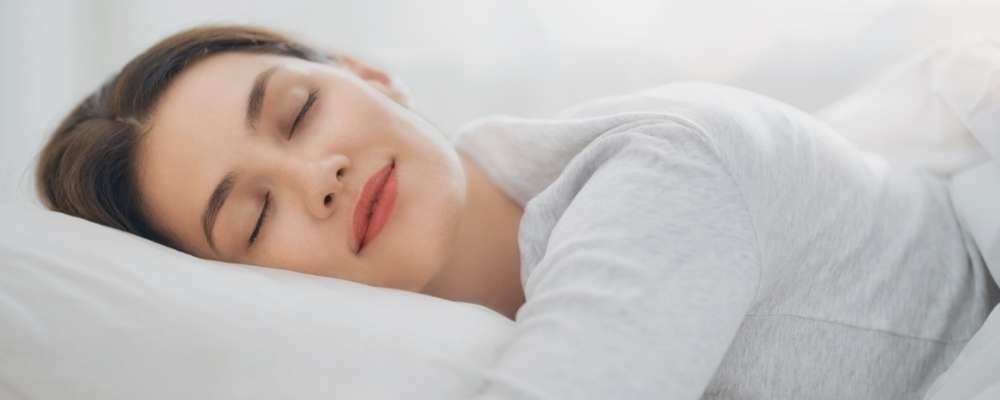 young woman sleeping in bed