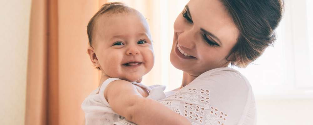 Mother smiling at baby