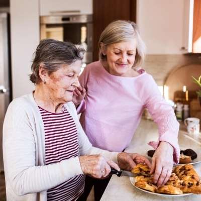 Woman helping elderly woman