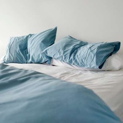 blue pillows on white bed