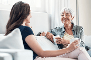 daughter and mother talking on couch