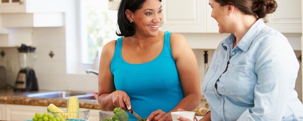 two girlfriends cooking in the kitchen